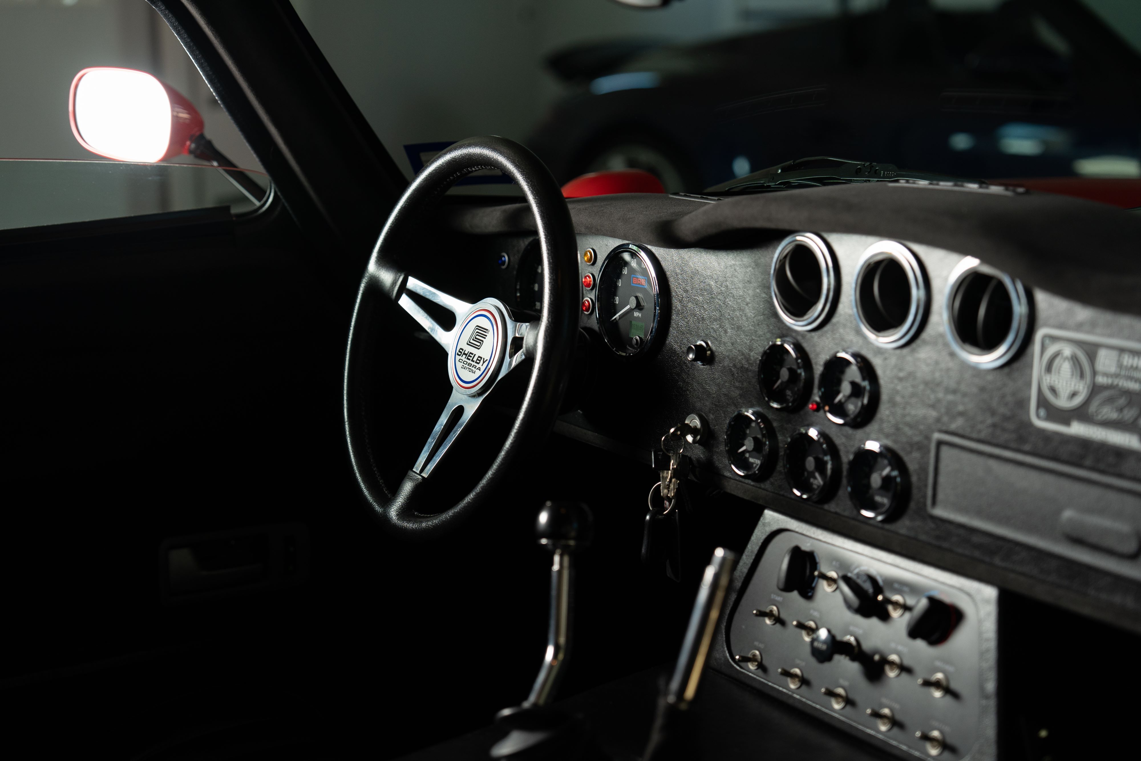 Interior of a 1965 Superformance Shelby Daytona CSX9000 in Monza Red.