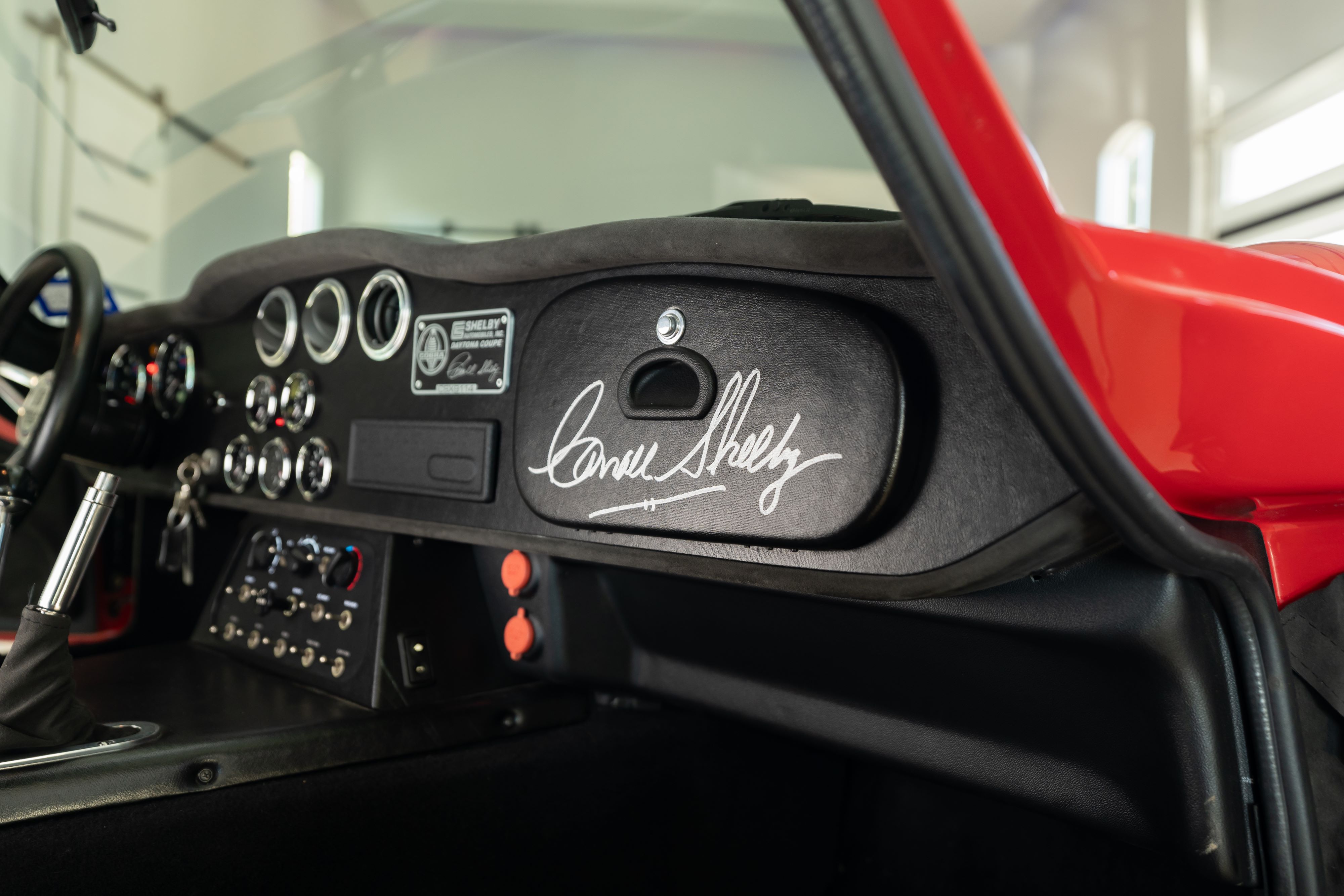 Interior of a 1965 Superformance Shelby Daytona CSX9000 in Monza Red.