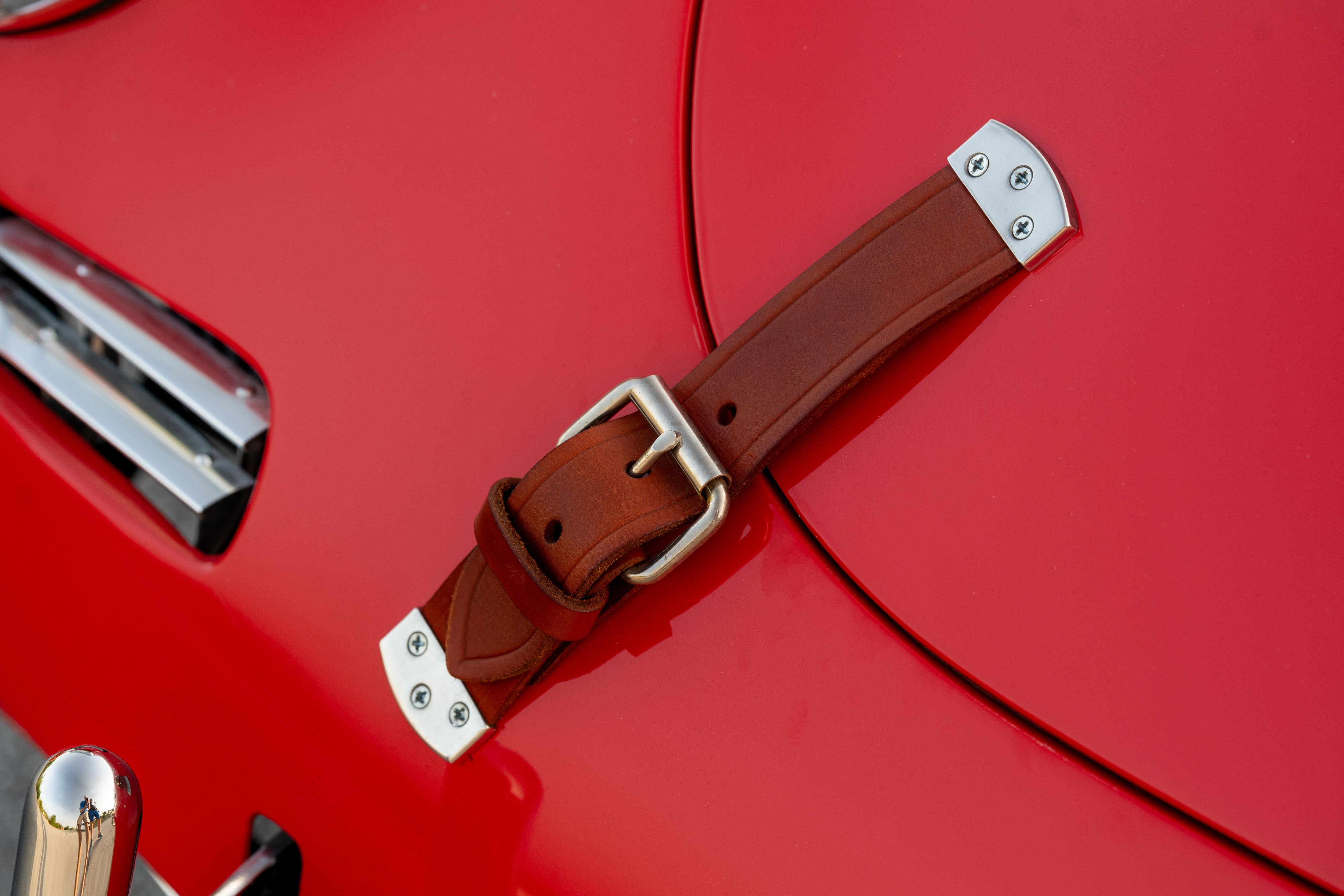 Leather hood straps on a 1965 Porsche 356C Coupe shot in Austin, TX.