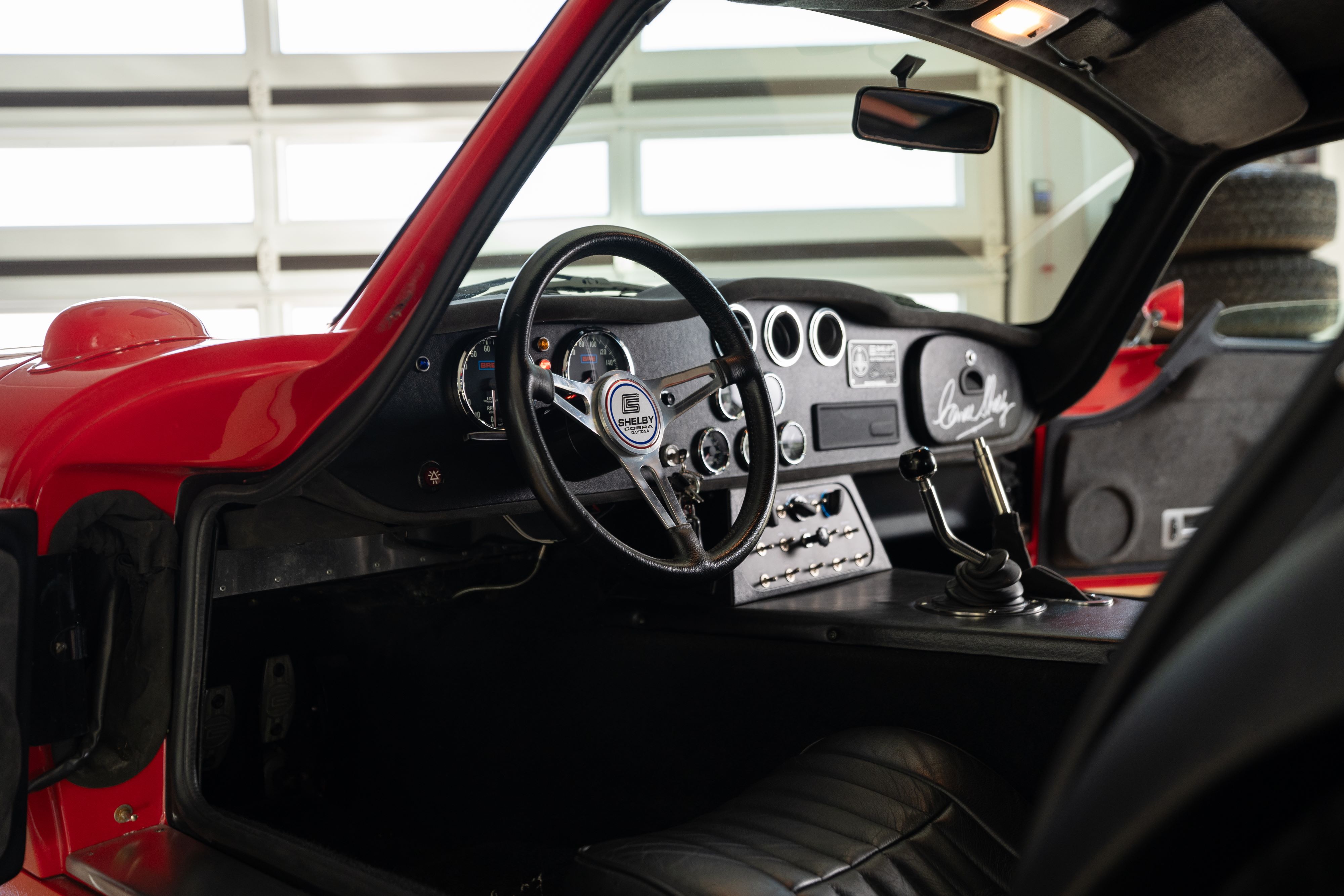 Interior of a 1965 Superformance Shelby Daytona CSX9000 in Monza Red.