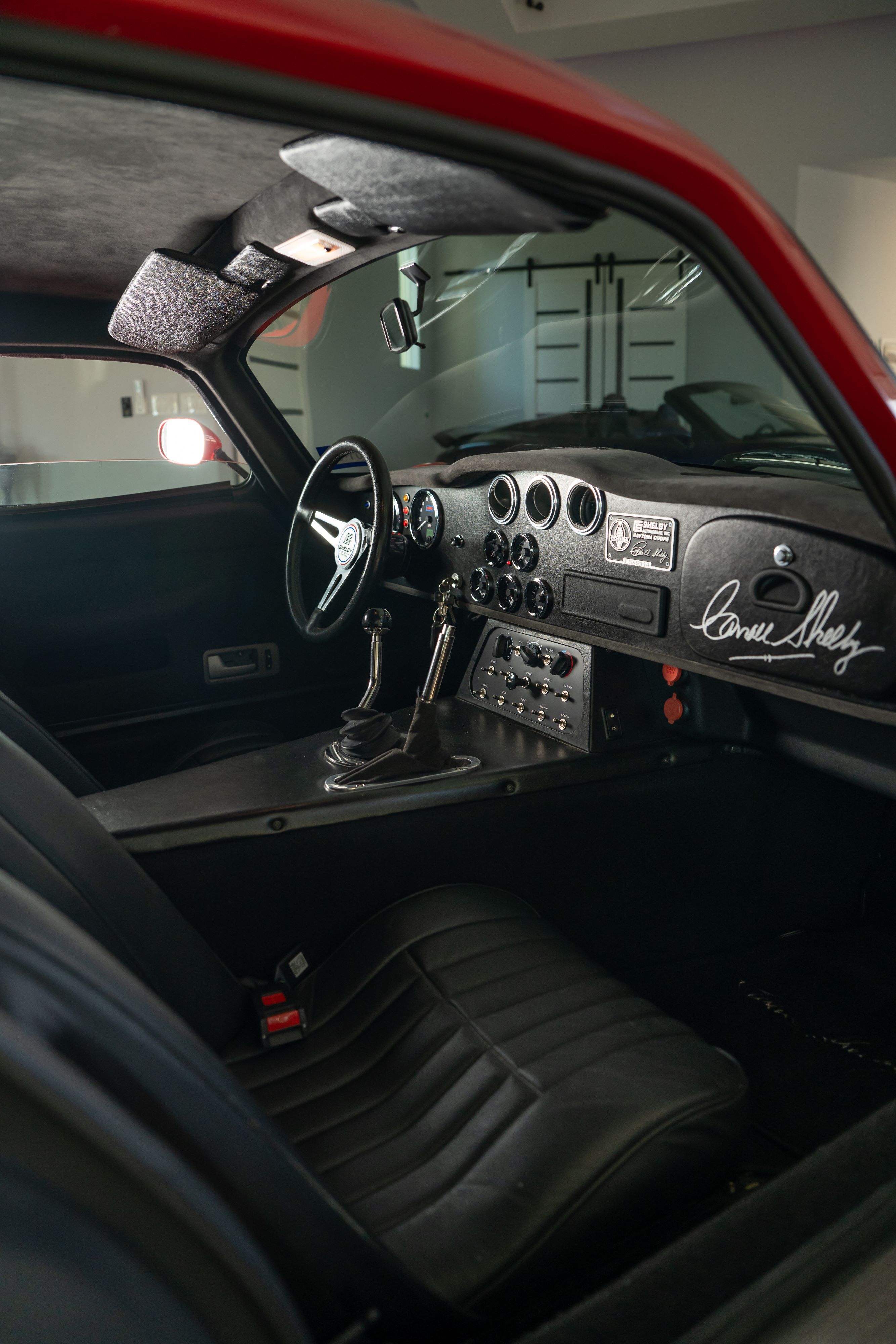 Interior of a 1965 Superformance Shelby Daytona CSX9000 in Monza Red.