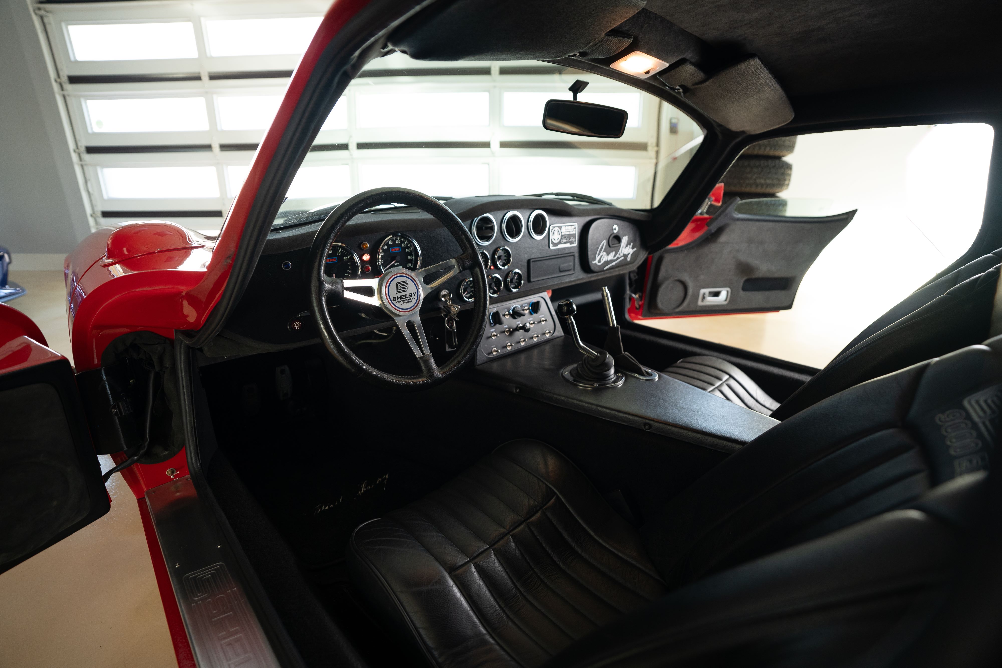 Interior of a 1965 Superformance Shelby Daytona CSX9000 in Monza Red.