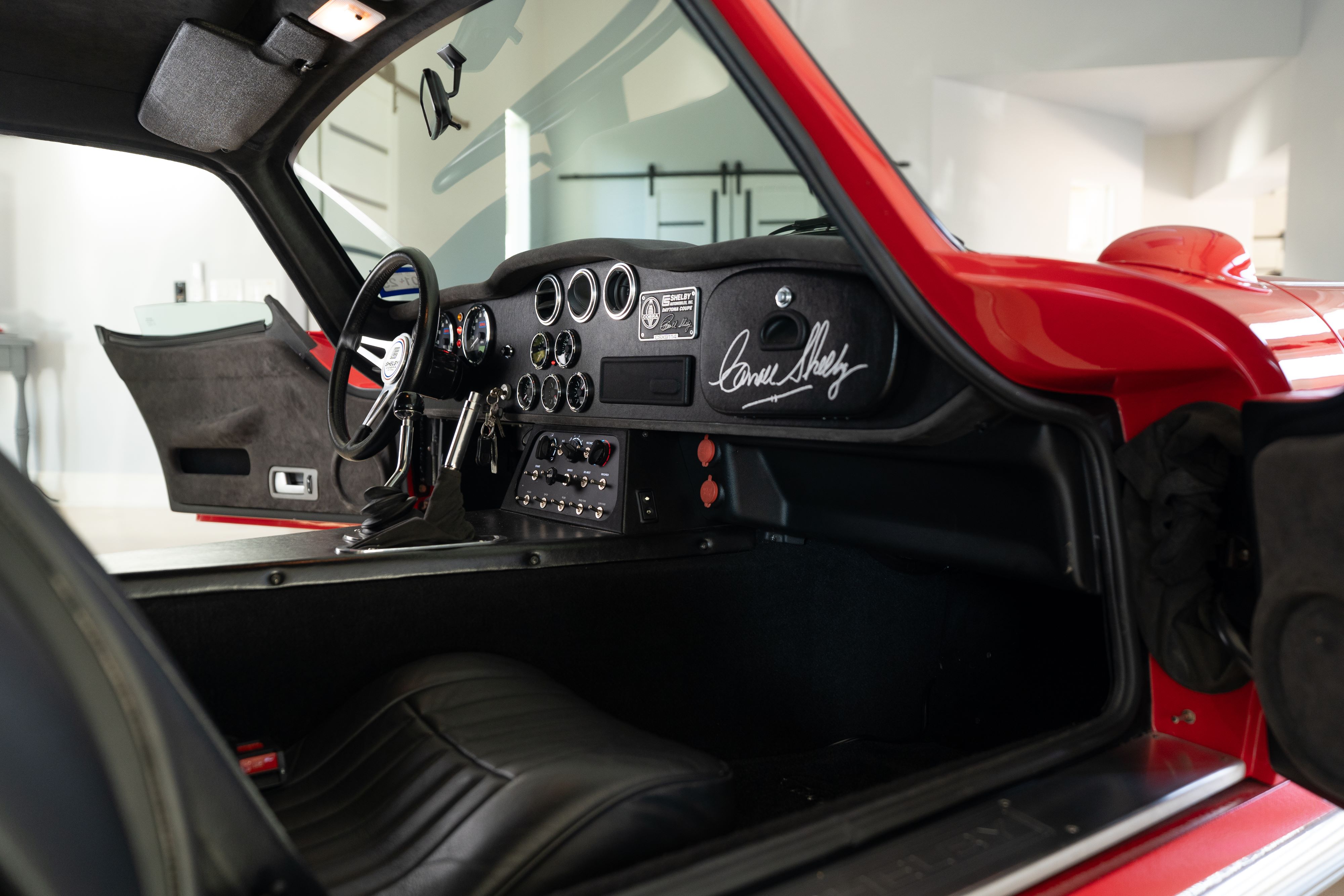 Interior of a 1965 Superformance Shelby Daytona CSX9000 in Monza Red.