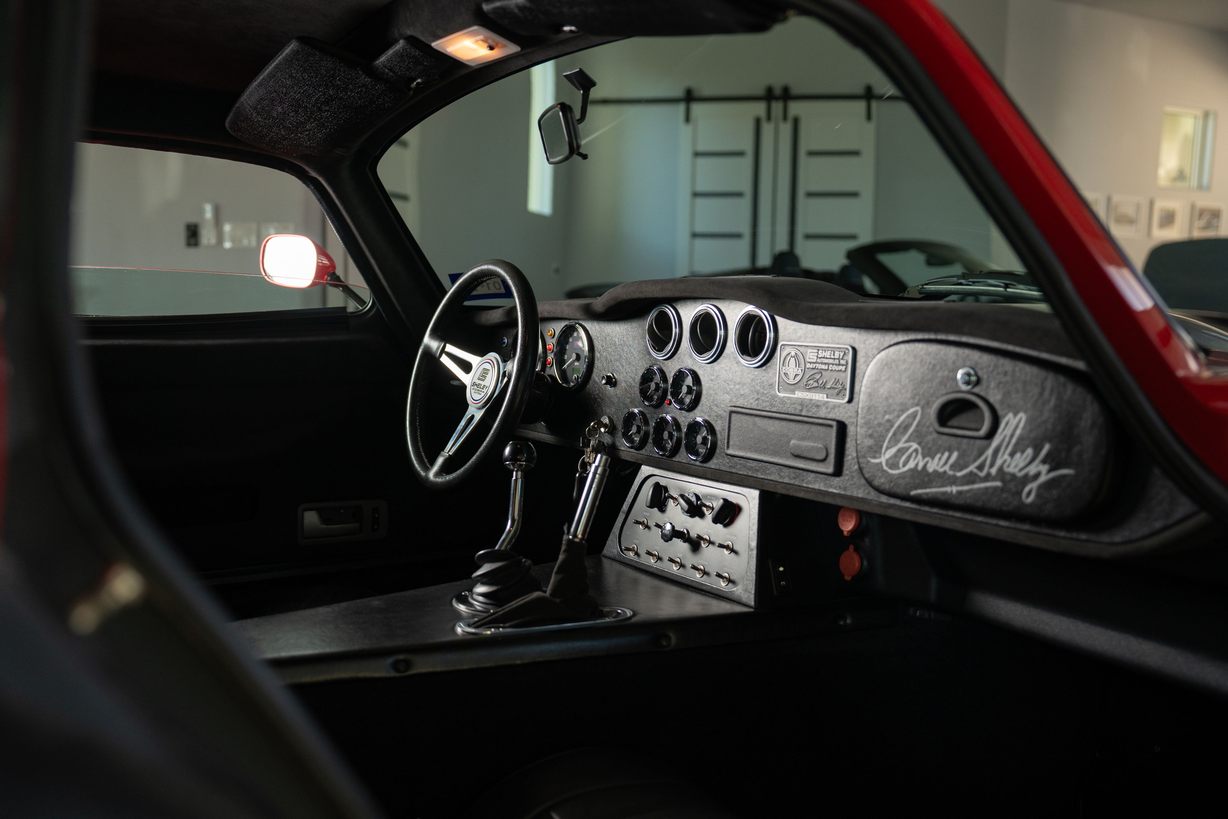 Interior of a 1965 Superformance Shelby Daytona CSX9000 in Monza Red.