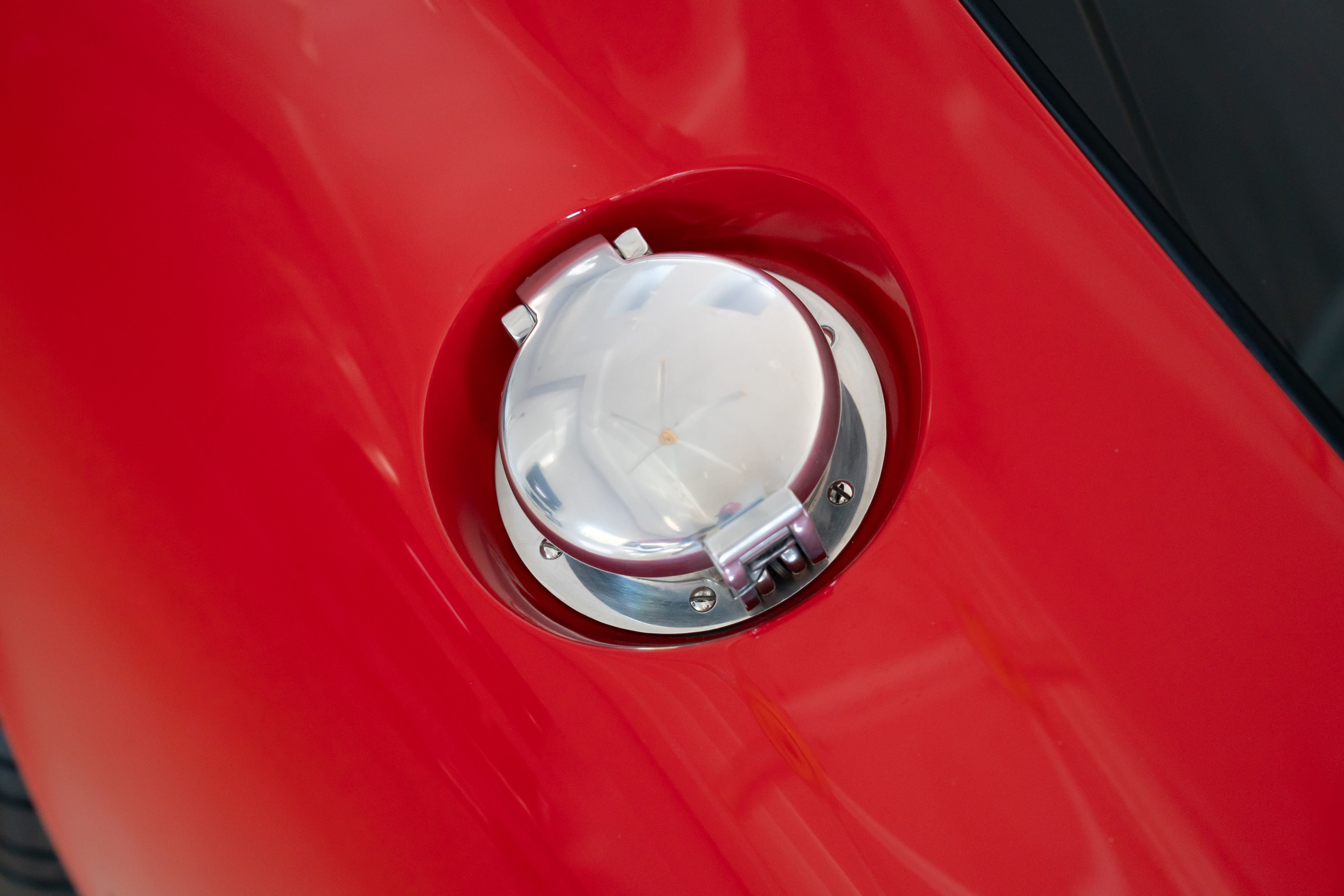 Gas cap on a 1965 Superformance Shelby Daytona CSX9000 in Monza Red.