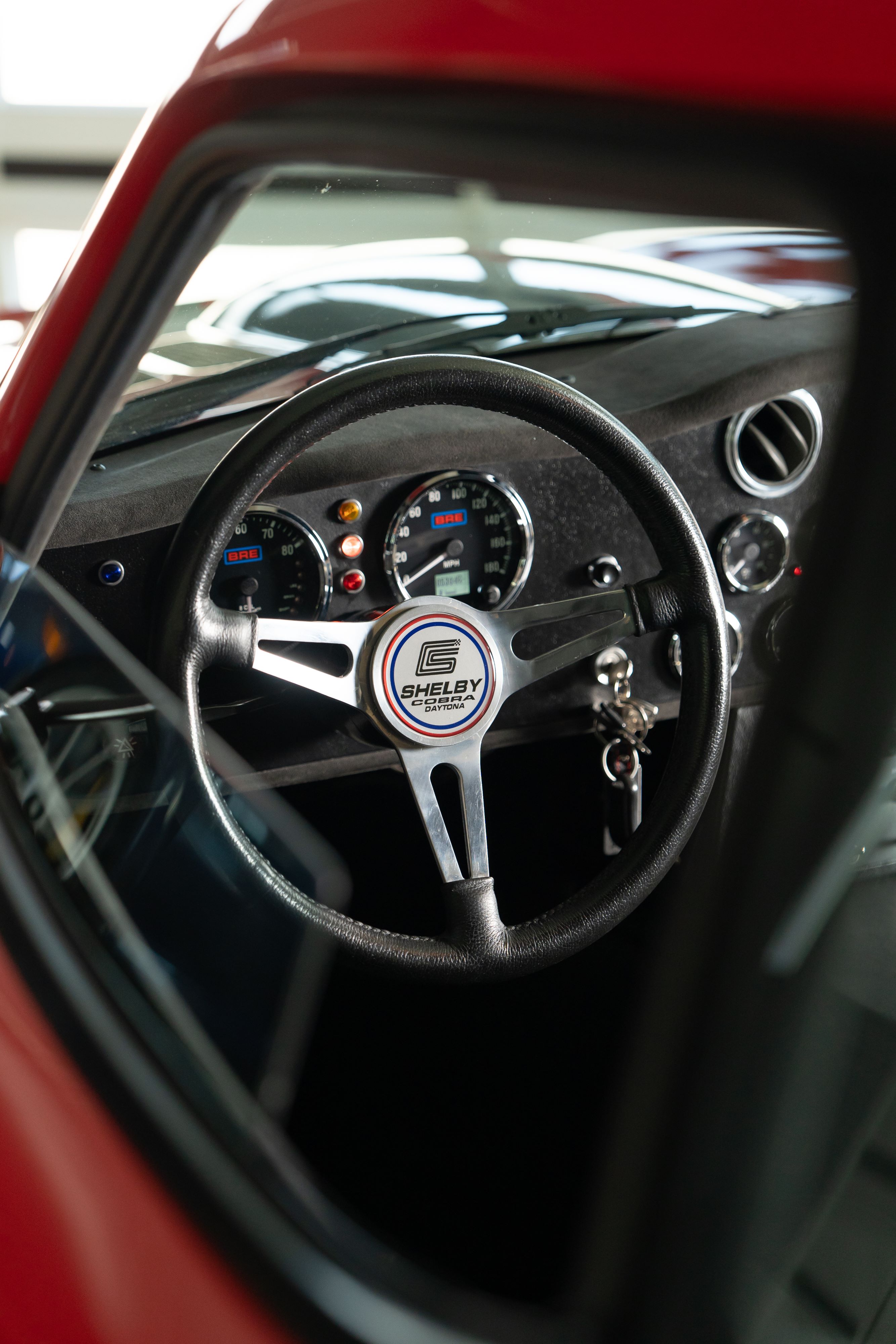 Interior of a 1965 Superformance Shelby Daytona CSX9000 in Monza Red.