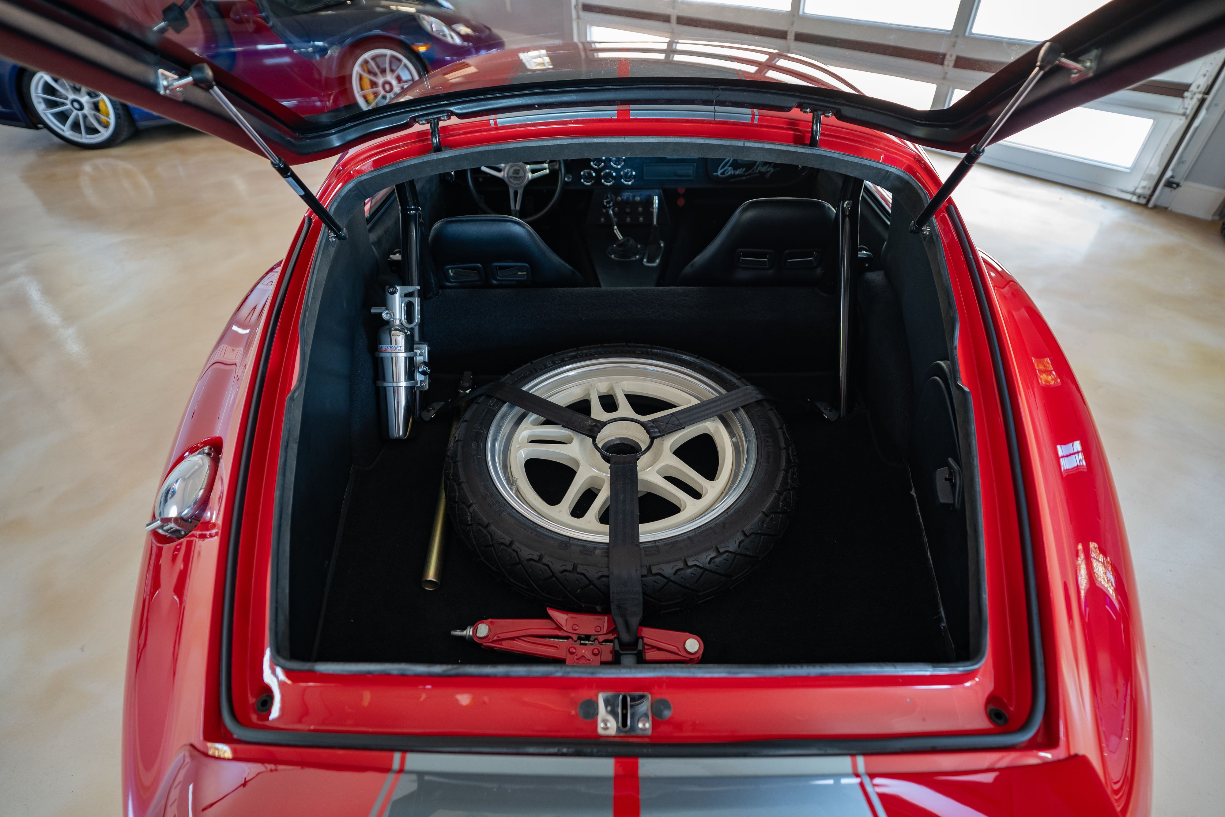 Spare wheel in the truck of a 1965 Superformance Shelby Daytona CSX9000 in Monza Red.