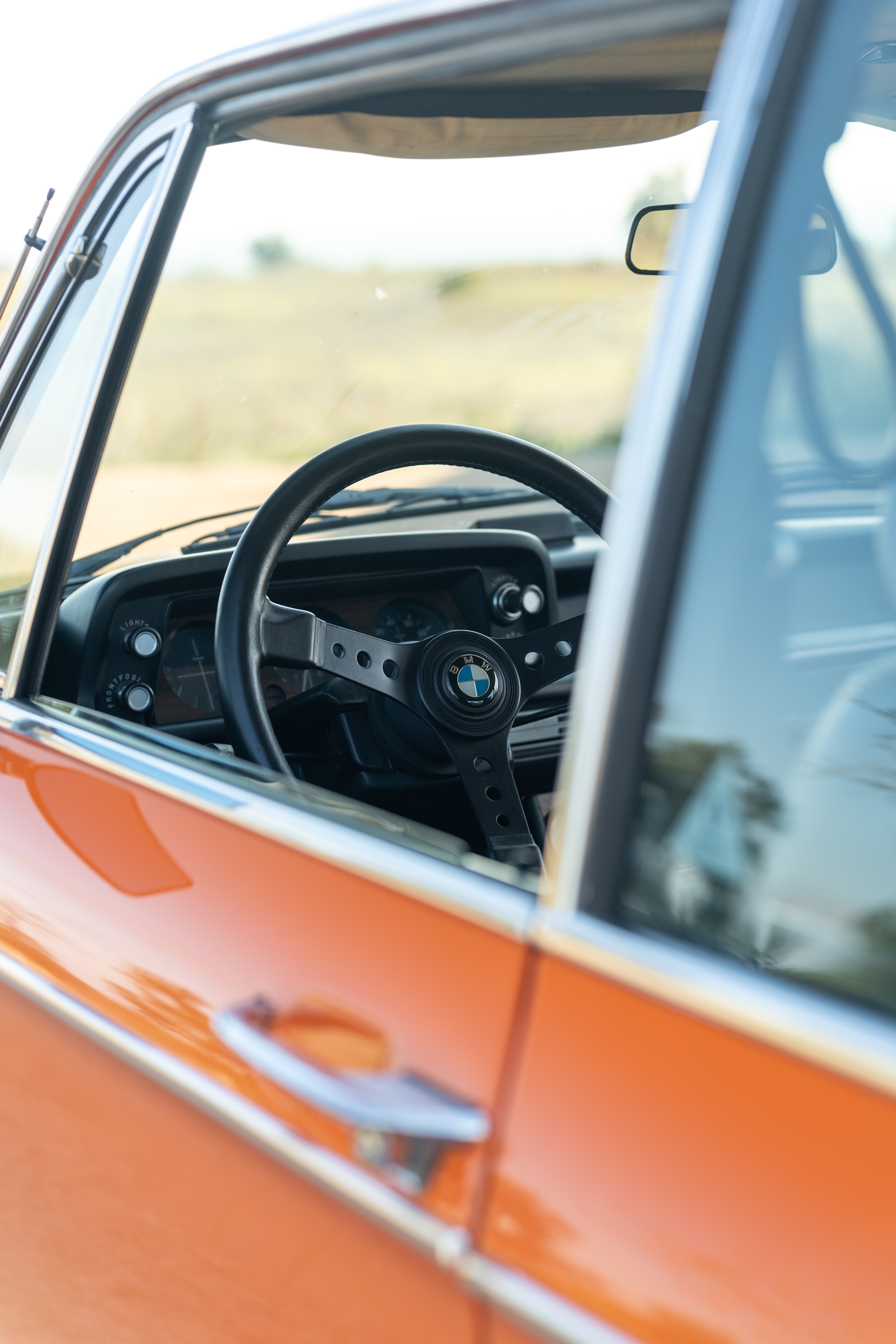 Black interior on an Orange 1976 BMW 2002 2.2L 5-Speed shot in Blanco, TX.