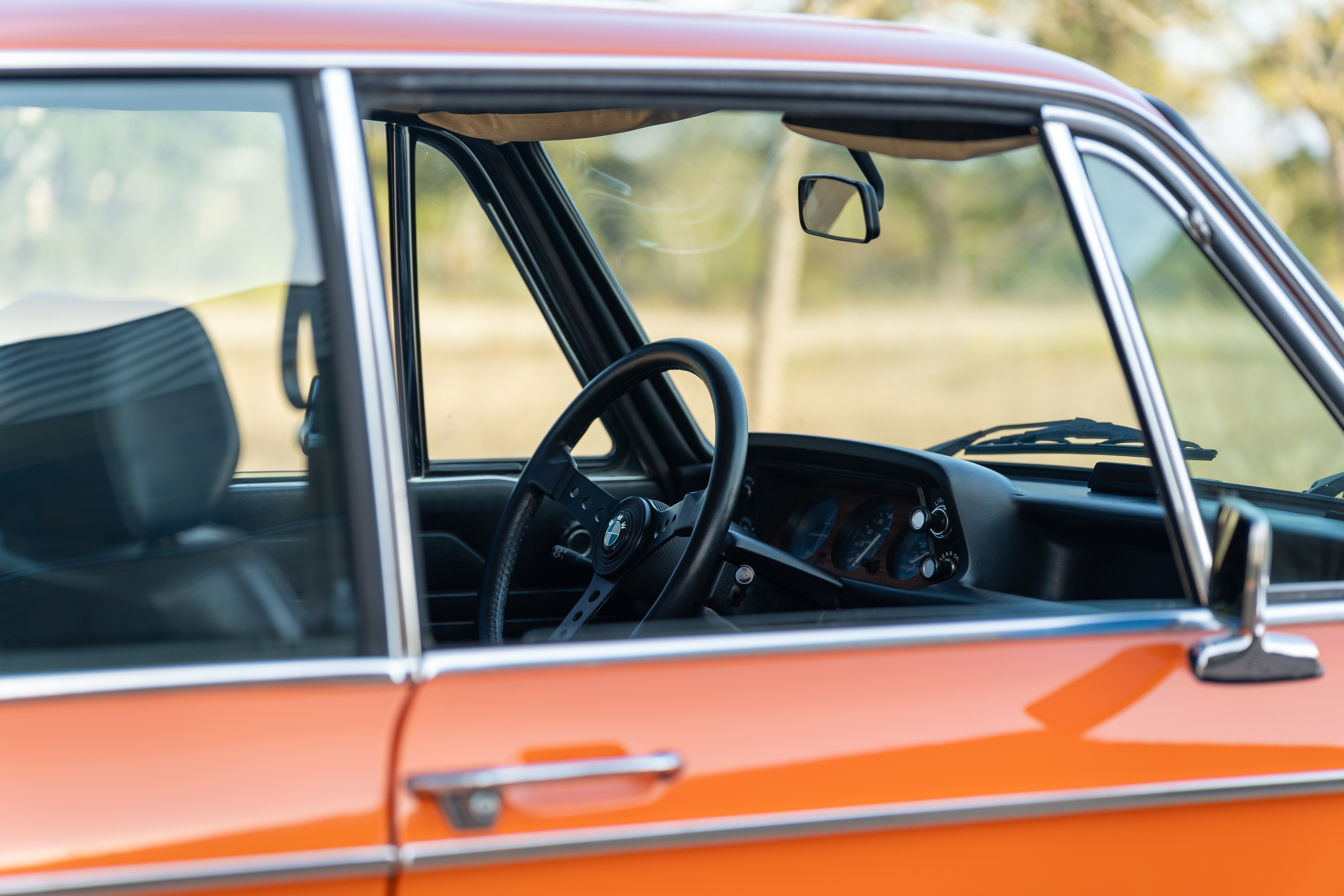 Black interior on an Orange 1976 BMW 2002 2.2L 5-Speed shot in Blanco, TX.