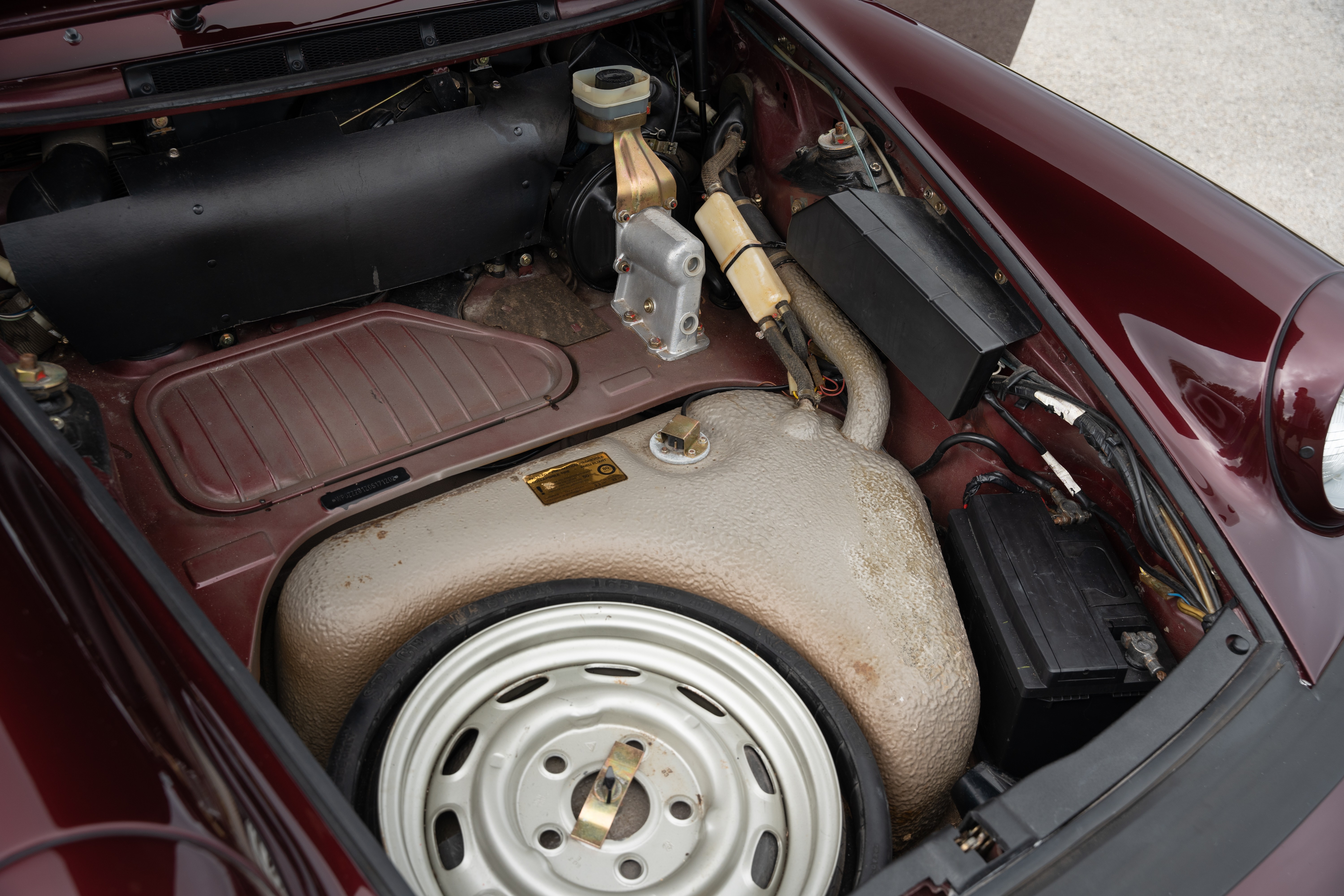 Frunk on a 1983 Porsche 911SC Cabriolet in Metallic Red shot in Austin, TX.