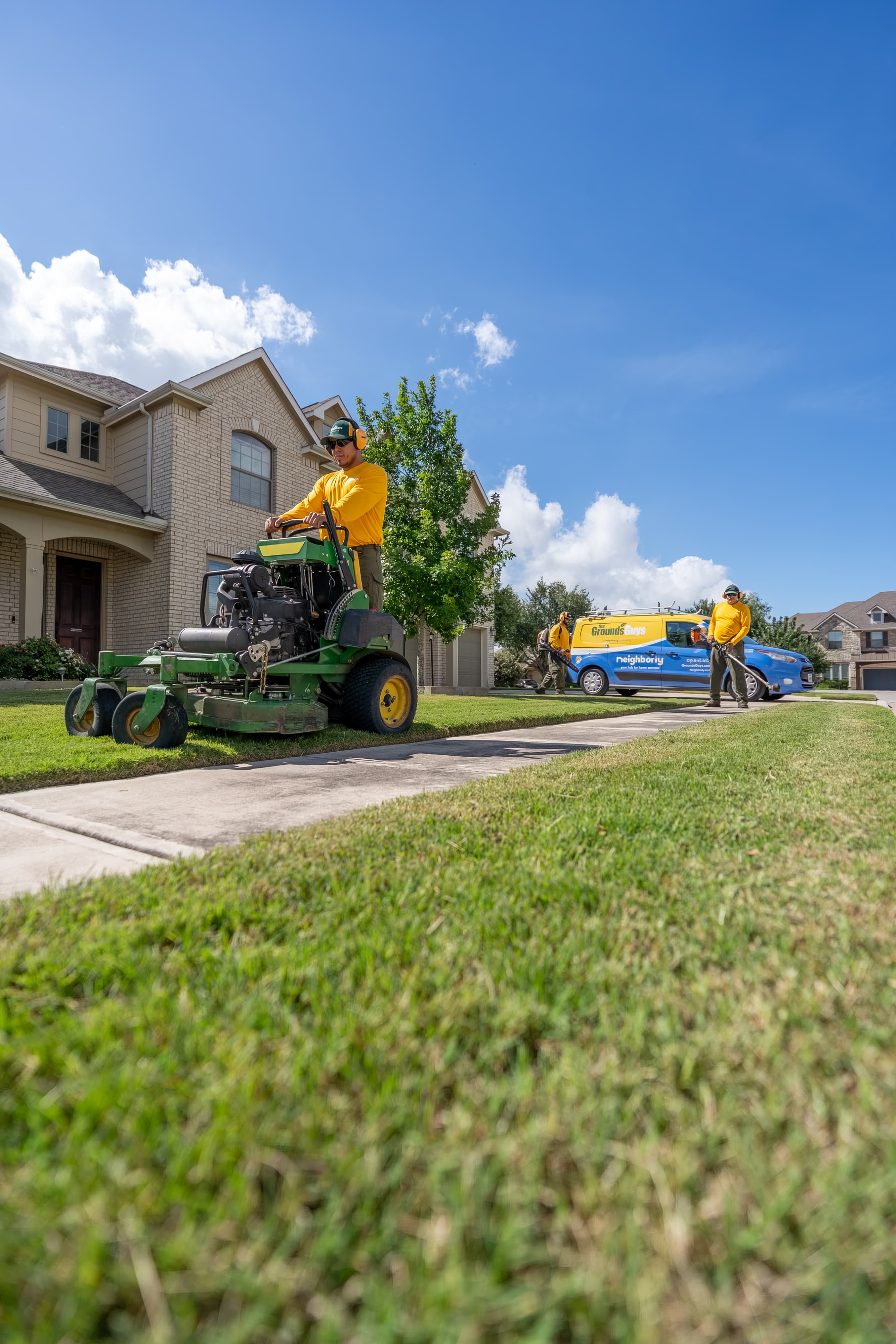 Grounds Guys maintenance crew doing yardwork and sprinkler maintenance.