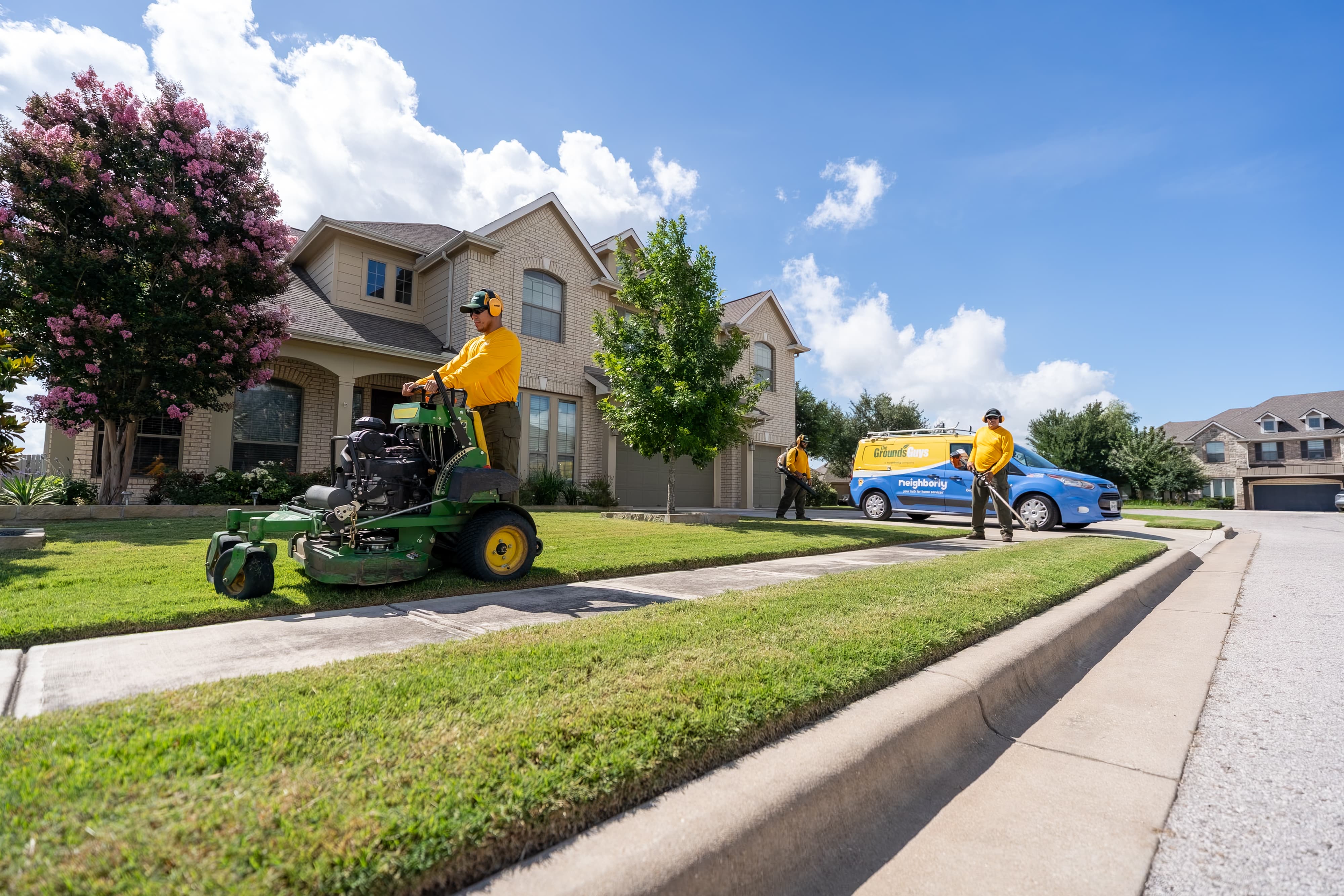 Grounds Guys maintenance crew doing yardwork and sprinkler maintenance.