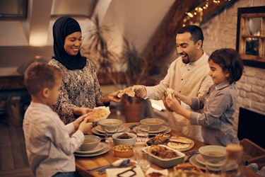 Muslim family enjoying meal together