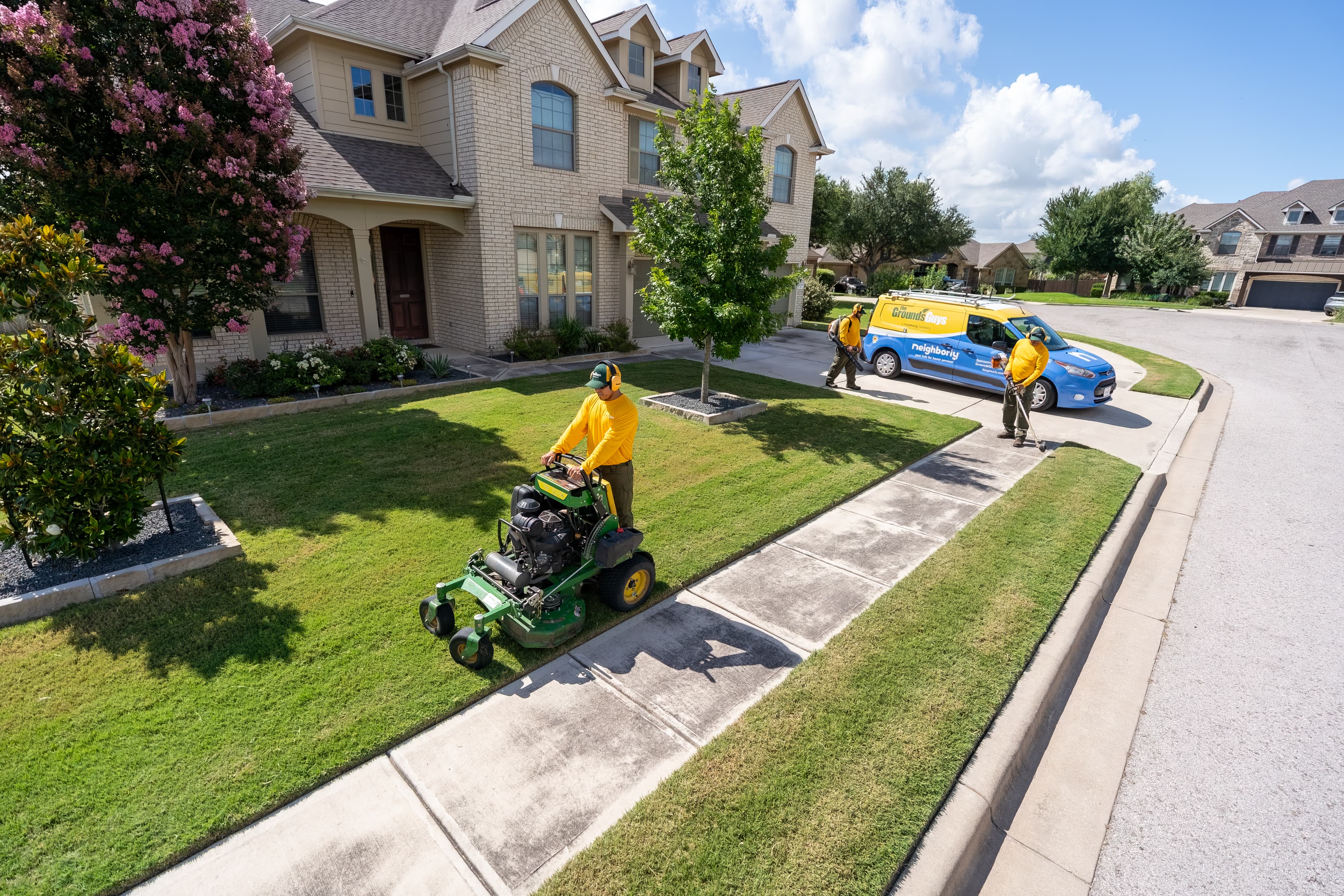 Grounds Guys maintenance crew doing yardwork and sprinkler maintenance.