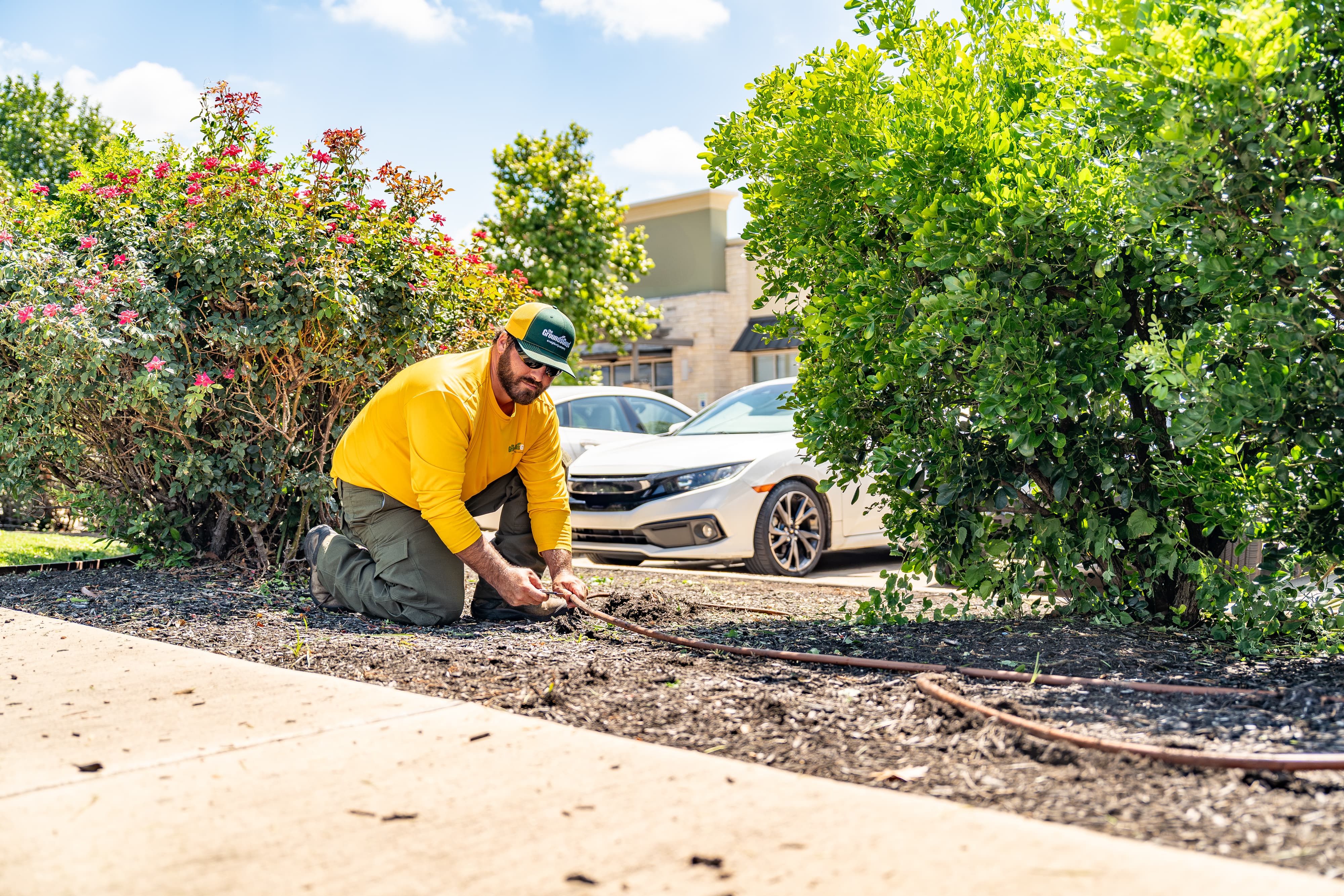 Grounds Guys maintenance crew working on a commercial landscaping project.
