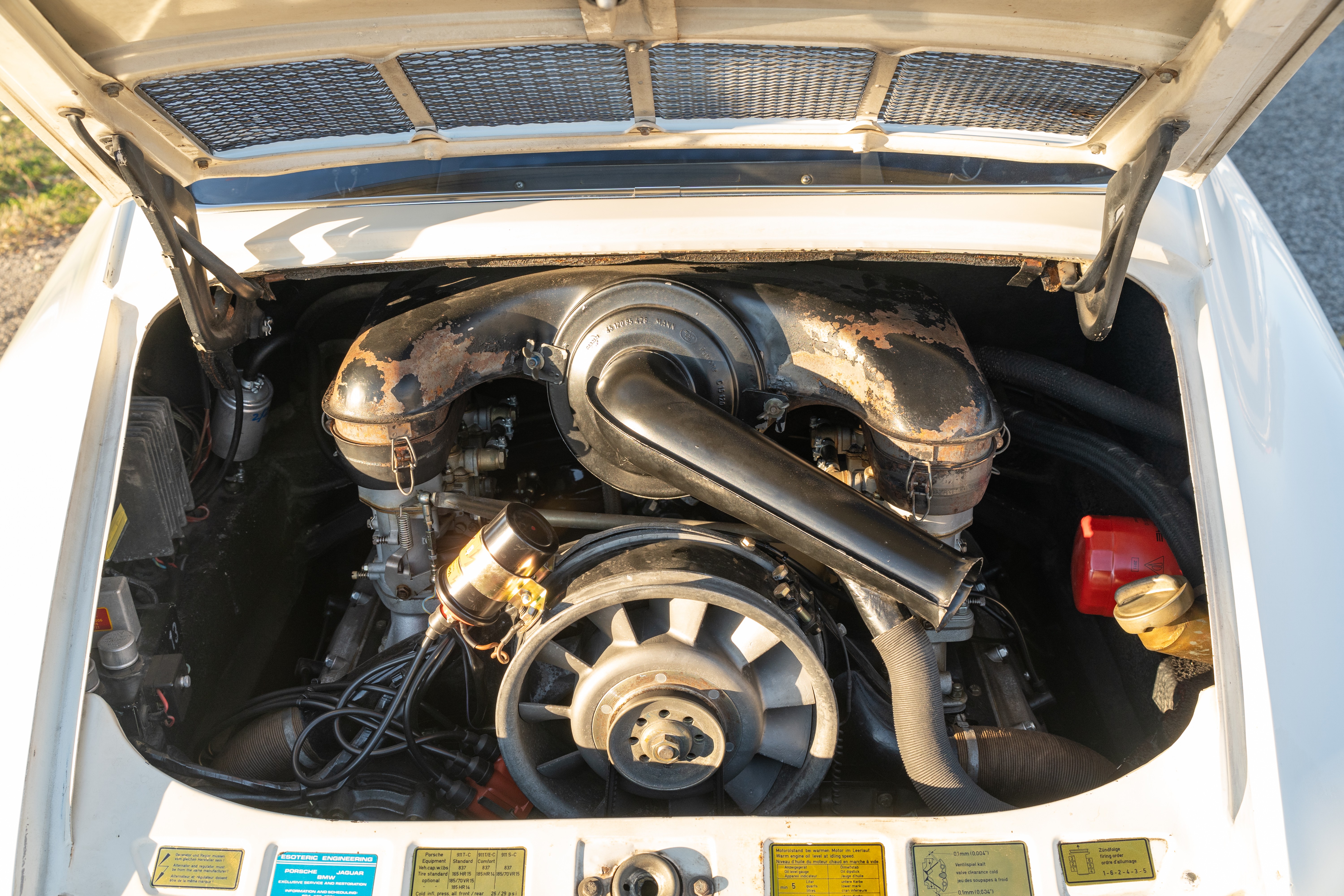 Engine bay of a White 1970 Porsche 911T Coupe with a black interior shot in Austin, TX.