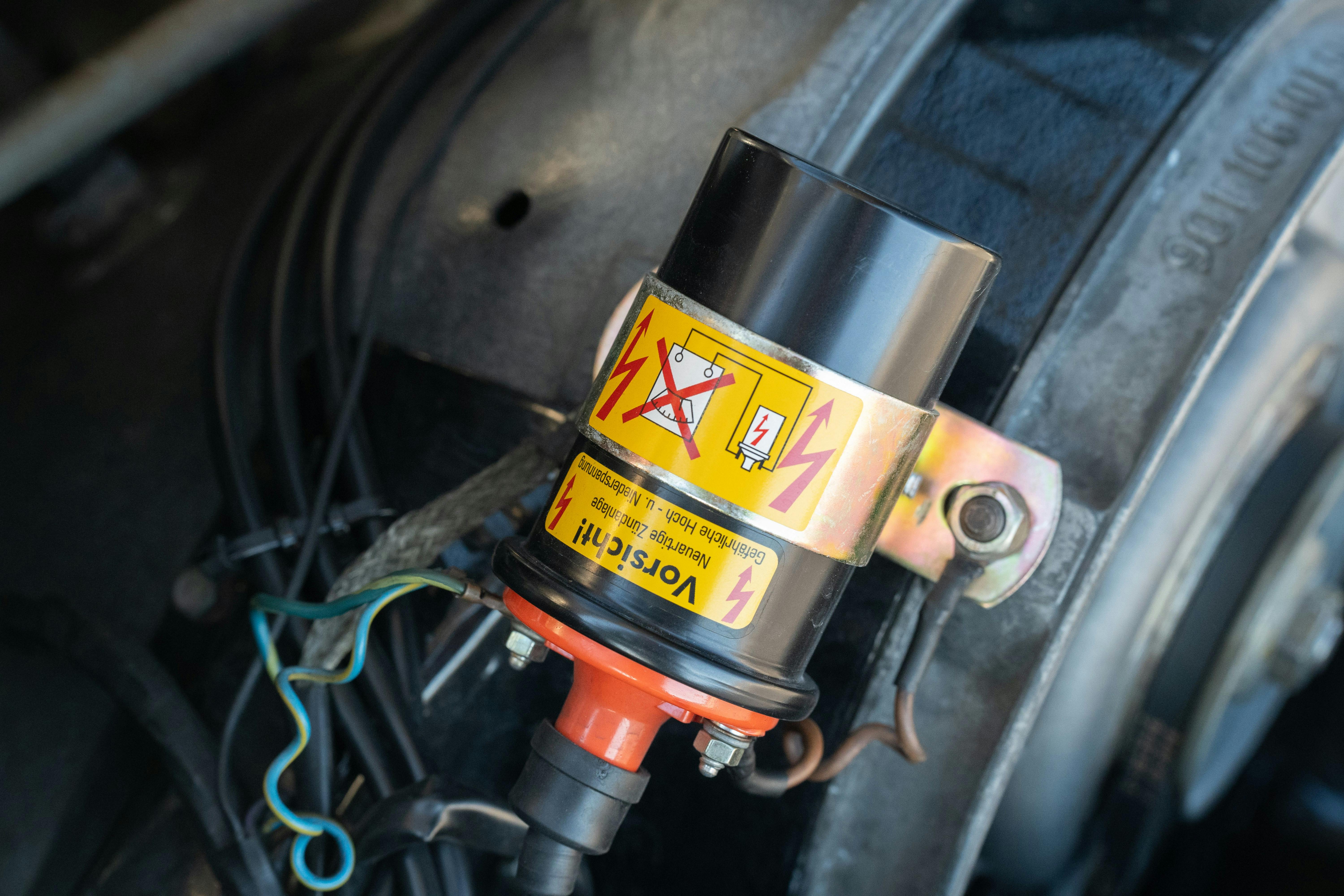 Engine bay of a White 1970 Porsche 911T Coupe with a black interior shot in Austin, TX.