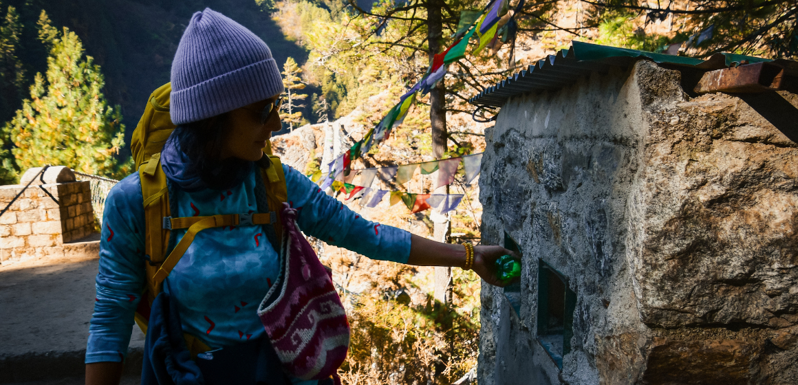 Female-trekker-placing-plastic-bottle-at-official-waste-point-in-Everest-region---The-Adventure-People.png