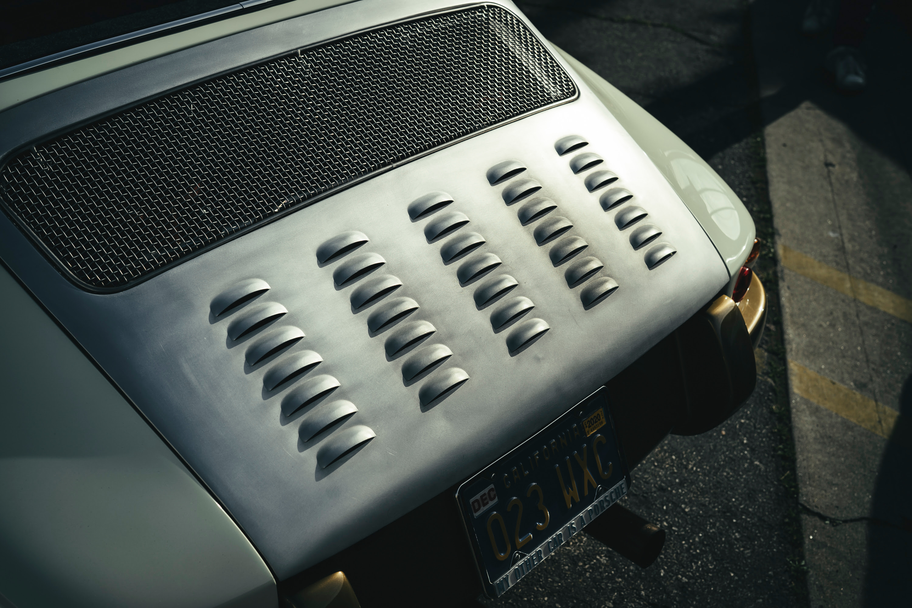 A cream and gold modfied 911 at Callas Rennsport with a vented engine cover.