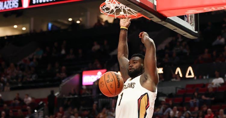Zion Williamson finishing off a dunk.