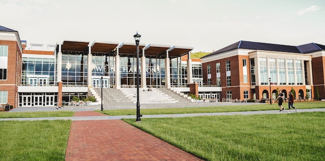 University building entrance seen from its front lawn