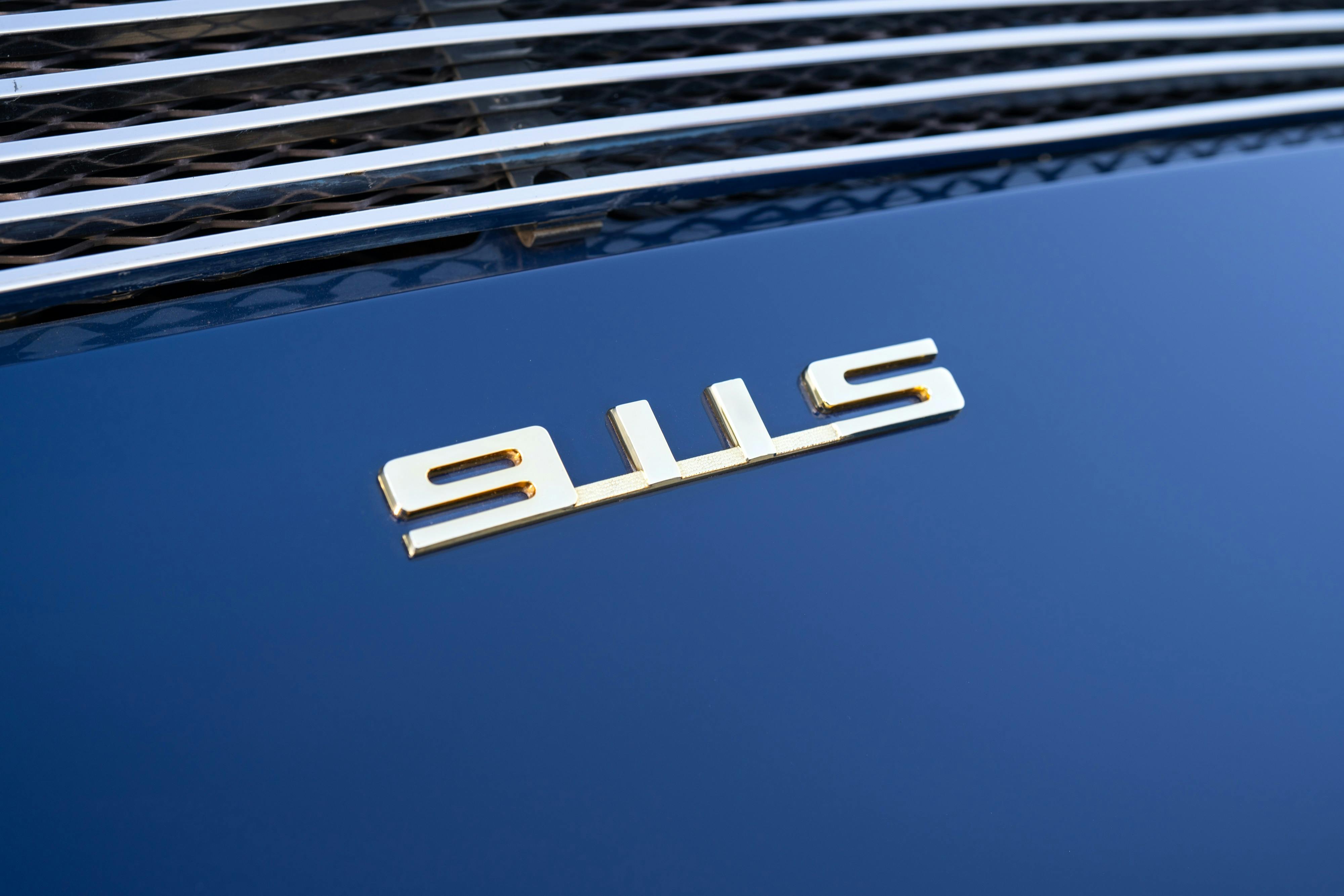 Badging on a 1969 Porsche 911S in Ossi Blue over Red.