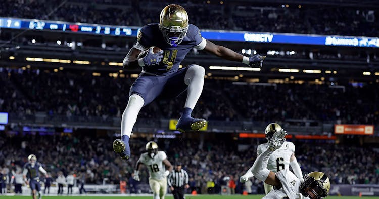 Jeremiyah Love jumps an opponent to score.