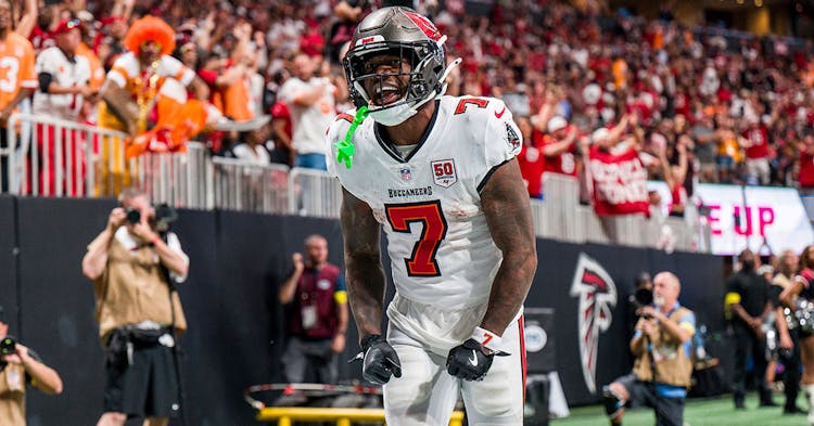 Bucky Irving celebrates scoring a touchdown.