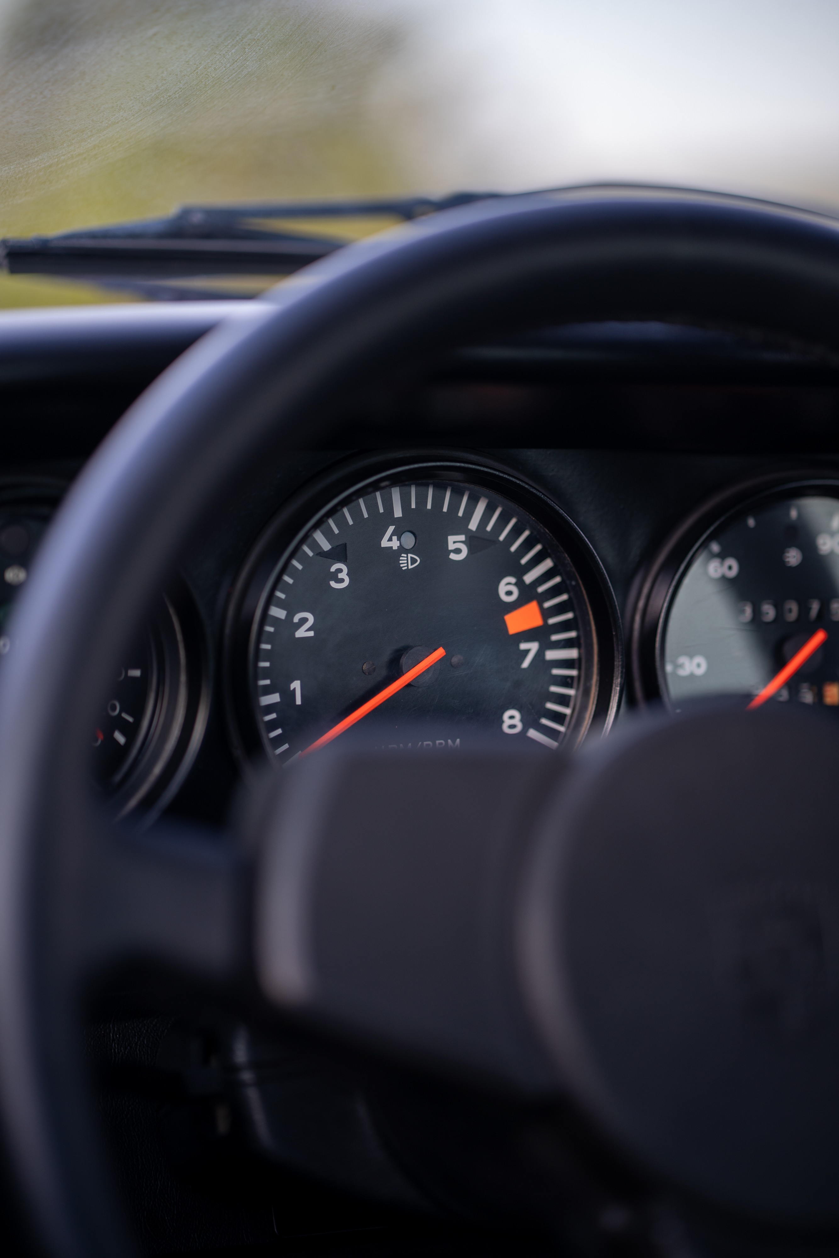 Gauges in a 1974 Porsche 911 Carrera Targa in Peru Red over Black.